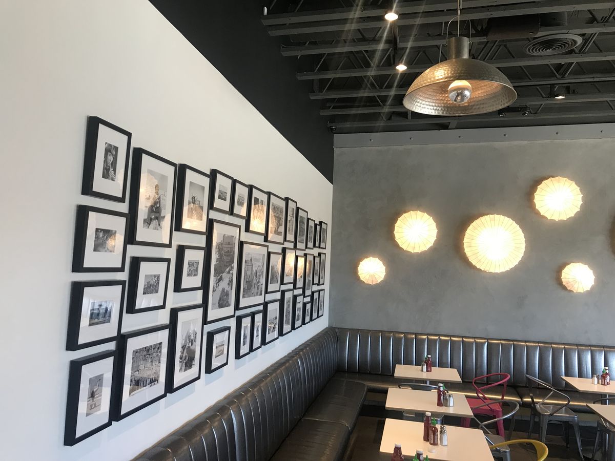 Framed black and white gallery wall in a restaurant dining room