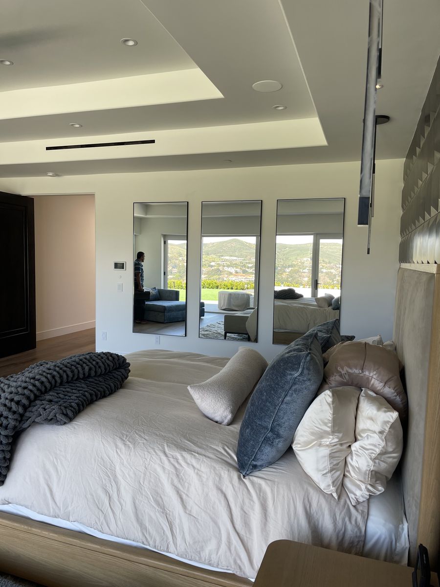 Three custom mirrors installed in a hillside bedroom